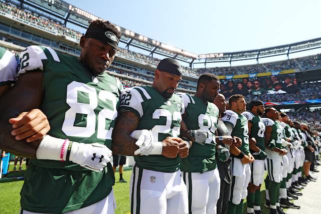 The Jets stood and locked arms during the anthem before Sunday's game.